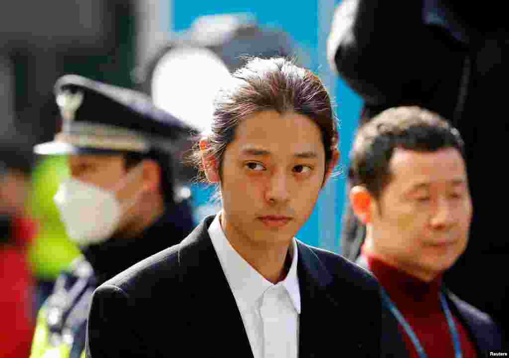 South Korean singer Jung Joon-young arrives for questioning on accusations of illicitly taping and sharing sex videos on social media, at the Seoul Metropolitan Police Agency in Seoul.