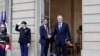New French prime minister Michel Barnier, right, shakes hands with outgoing prime minister Gabriel Attal during the handover ceremony, Sept. 5, 2024 in Paris. 