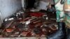 A Syrian Army soldier stands near blood on the ground of a damaged emergency room inside National Hospital after explosions hit the Syrian city of Jableh, May 23, 2016. 