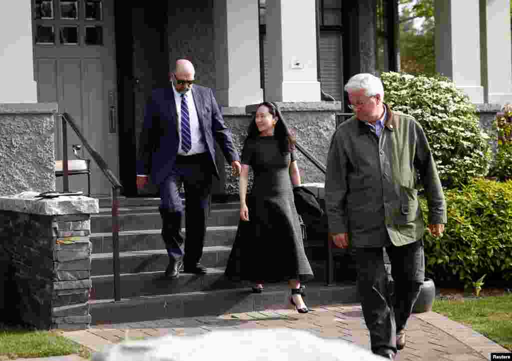 Huawei's Financial Chief Meng Wanzhou wearing an ankle monitor, leaves her family home with her private security in Vancouver, British Columbia, Canada, May 8, 2019.