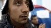 FILE - Yosri Adjili, 25, who is unemployed, goes on a hunger strike with his mouth sewed shut during a sit-in protest to get jobs, at the local government office courtyard in Kasserine, Tunisia, Jan. 27, 2016. 