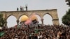 Palestinians celebrate in the streets following a cease-fire brokered by Egypt between Israel and the ruling Islamist movement Hamas in the Gaza Strip, on May 21, 2021, in Gaza City.