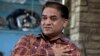 FILE - Ilham Tohti, an outspoken scholar of China's Turkic Uighur ethnic minority, speaks during an interview at his home in Beijing, China, Feb. 4, 2013.