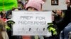 A woman holds a sign promoting voting in the upcoming midterm elections during a Women's March in Seattle, Jan. 20, 2018.