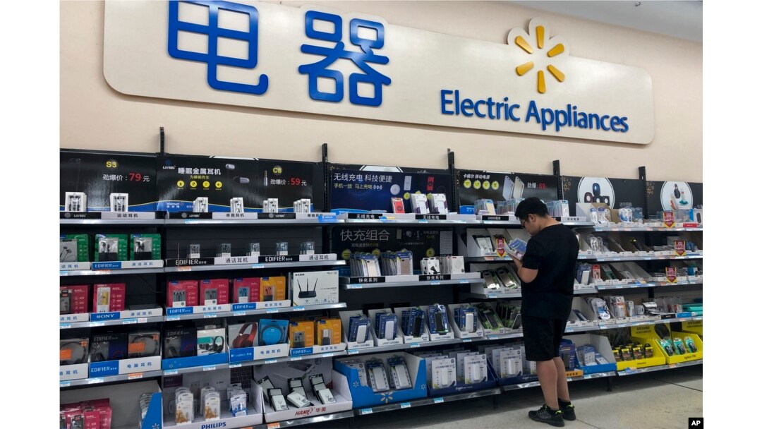 A man looks at digital accessories in Beijing, May 9, 2019. Ratcheting up tension ahead of talks, China vowed Thursday to defend its own interests and retaliate if President Donald Trump goes ahead with more tariff hikes in a dispute over trade and technology.
