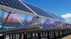FILE - Solar panels that are part of the Wright-Hennepin Cooperative Electric Association's community gardens are shown in Rockford, Minn., Feb. 26, 2015. Community solar gardens allow customers who cannot put up solar panels to buy into the green energy boom anyway. 