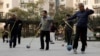 Retirees practice "Cola Ball" with music, an invented community activity in central Beijing, Oct. 17, 2013. China is close to announcing long-awaited reforms to its pension system, whose assets are estimated to have already fallen $3 trillion behind projected future payouts.