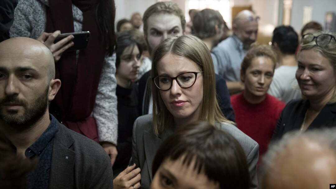 Russian socialite and opposition member Kseniya Sobchak waits outside a court where Russian theater and film director Kirill Serebrennikov attends a hearing, in Moscow, Oct. 17, 2017.
