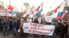 FILE - Protesters carry a banner reading "Together for decent medical care!" as they march in a street in Moscow, Russia, Nov. 30, 2014.