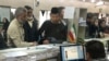 FILE - Afghan refugees submit documents at a refugee center in Tehran, Iran, Oct. 24, 2016. UNHCR estimates that 3 million Afghans are living in Iran.