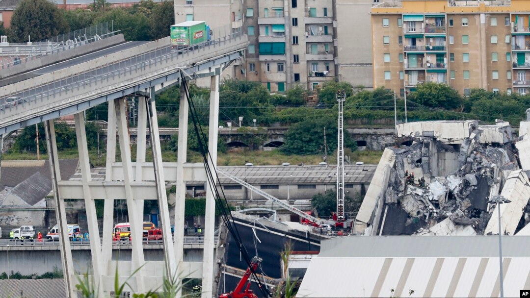 Cars are blocked on the Morandi highway bridge after a section of it collapsed, in Genoa, northern Italy, Aug. 14, 2018. 
