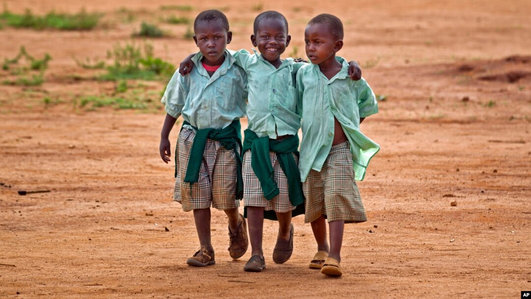 FILE - Young schoolboys walk home in the village of Nyumbani, Kenya, which caters to children who lost their parents to HIV, and grandparents who lost their children to HIV.