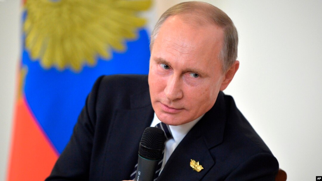 Russian President Vladimir Putin speaks to Russian journalists during a news conference following the BRICS summit in Goa, India, Oct. 16, 2016. Putin is denying allegations of Russian government interference with the U.S. election process.