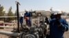 FILE - Workers check the valves at the Taq Taq oil field in Irbil, in Iraq's Kurdistan region. 