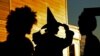 FILE - Parents wait as their children trick-or-treat at a shopping center in Freeport, Maine, Oct. 31, 2017.