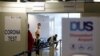 FILE - Travelers line up at the new Corona Test Center at Duesseldorf Airport in Duesseldorf, Germany, July 27, 2020. Travellers can take a voluntary test for the coronavirus disease following travel to avoid two weeks of quarantine.