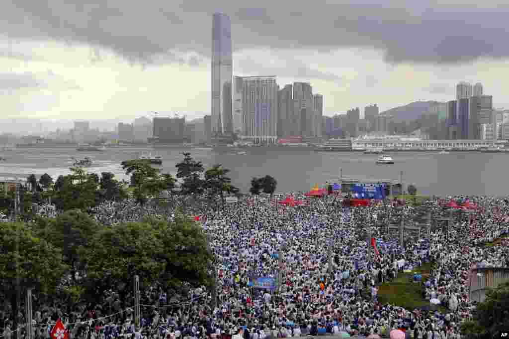 Pro-China's supporters hold Chinese flags and placards read "We support police" during a rally outside Legislative Council Complex in Hong Kong.