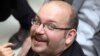 FILE - Jason Rezaian, an Iranian-American correspondent for the Washington Post smiles as he attends a presidential campaign of President Hassan Rouhani in Tehran, Iran.