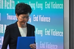 FILE - Hong Kong Chief Executive Carrie Lam leaves after a press conference in Hong Kong, Oct. 4, 2019.