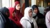 FILE - A group of women listen to Council on American-Islamic Relations-Minnesota Executive Director Jaylani Hussein, speaking about the Somali community concerns about the proposed government-initiated Countering Violent Extremism (CVE) program during a news conference in Minneapolis, Aug. 6, 2015.