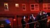 FILE - Emergency officials gather near the site where two police officers were shot in the Bronx section of New York.
