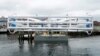 FILE - The Energy Tide 2, the largest tidal energy turbine ever deployed in the U.S., appears on a barge in Portland, Maine. 