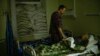 FILE - Dr. Ivan Mozhaiev attends to a patient during morning rounds at Pokrovsk hospital in Pokrovsk, Ukraine, on May 22, 2022. The country's health system is bracing for a second winter of war.