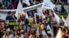 Syrian Yazidis march with pictures and banners during a demonstration in Amude, west of Qamishli, near the Syrian-Turkish border, Aug. 3, 2018, marking the fifth anniversary of IS attacks in the Sinjar mountains in Iraq's Yazidi heartland.