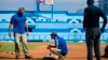 Murray Cook, left, and Phil Bradley, right, from the Major League Baseball Players Association talk to a worker during the refurbishing of the Latinoamericano stadium, March 16, 2016. The Tampa Bay Rays will play the Cuban national team March 22 in Havana.