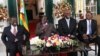 From left, Prime Minister Morgan Tsvangirai, President Robert Mugabe and other Zimbabwean officials address a press conference at the State House, Harare, Jan. 17, 2013.