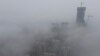 FILE -Buildings shrouded in heavy haze at Qingdao development zone, Shandong province, China.