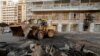 A bulldozer clears the rubble from a street after protests against the Lebanese government in Beirut, Oct. 19, 2019. The protests began after the government announced a slate of new proposed taxes, including a $6 monthly fee on Whatsapp voice calls. 