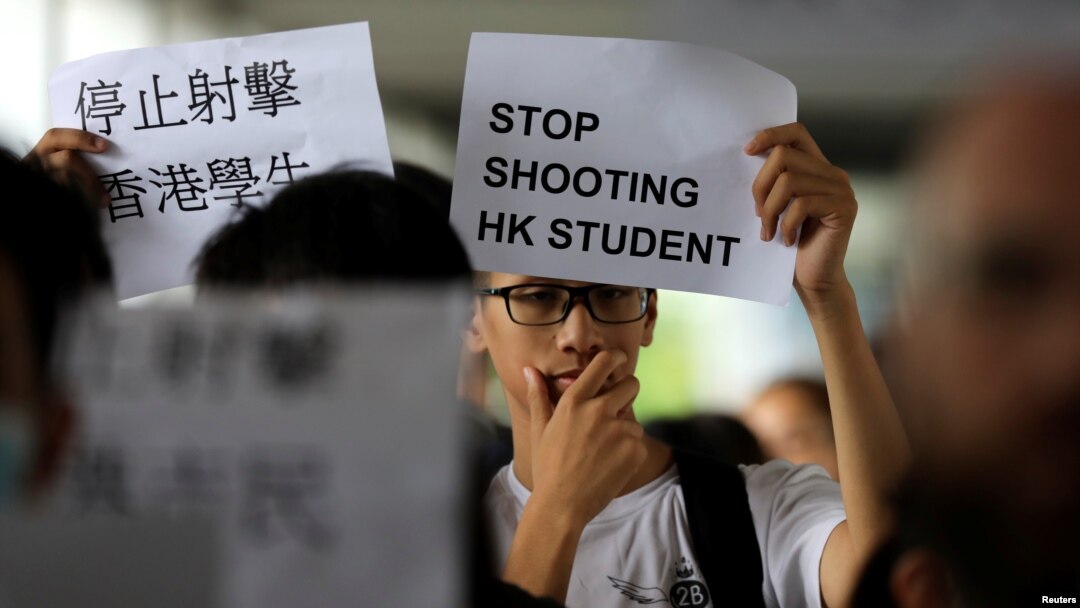 A protester holds a sign following a day of violence over an extradition bill that would allow people to be sent to mainland China for trial, in Hong Kong, June 13, 2019. 