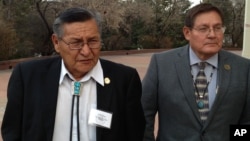 FILE - Ben Shelly, the President of the Navajo Nation, left, and Lorenzo Bates, Navajo Council Delegate walk outside the New Mexico Capitol in Santa Fe, New Mexico, Feb. 19, 2014. 