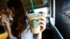A patron holds an iced beverage at a Starbucks coffee store in Pasadena, Calif., July 25, 2013. Straws and stirrers are among the top 10 items found in coastal trash cleanups.