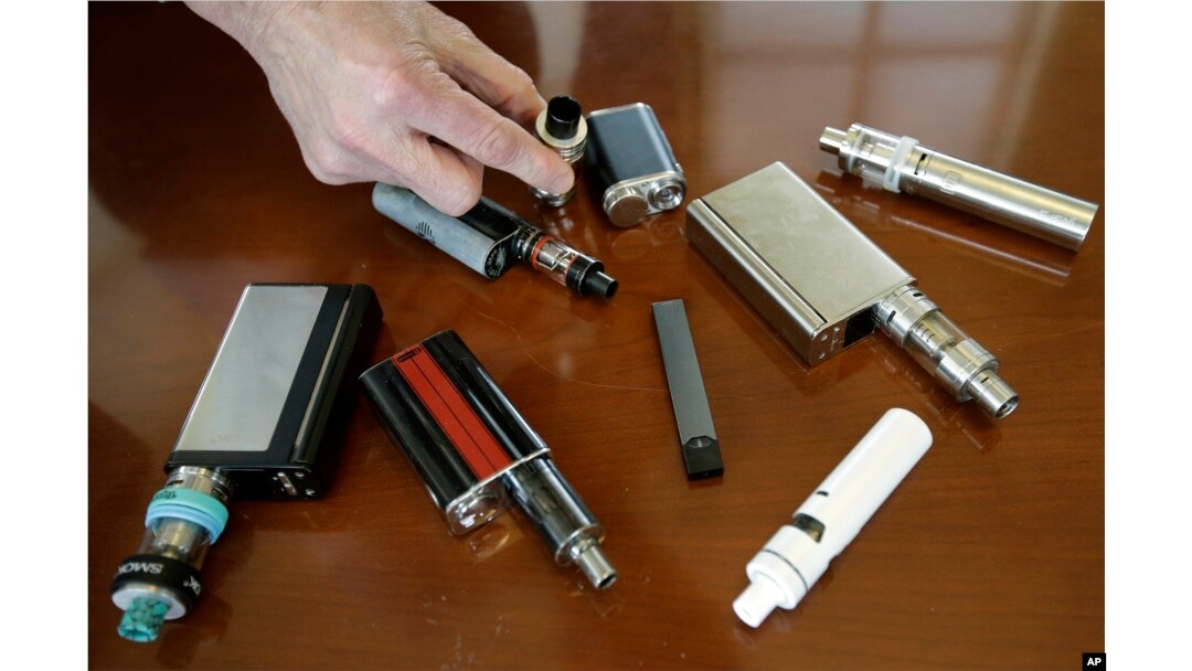 In this Tuesday, April 10, 2018 photo, vaping devices that were confiscated from students in such places as restrooms or hallways at the school in Marshfield, Mass.