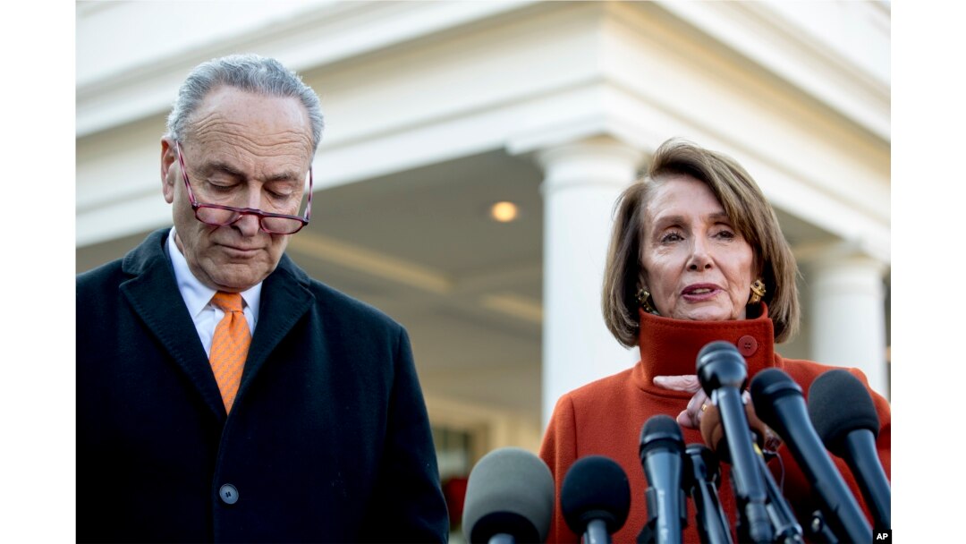 FILE - House Minority Leader Nancy Pelosi of Calif., right, accompanied by Senate Minority Leader Sen. Chuck Schumer of N.Y., left, speaks to members of the media outside the West Wing of the White House in Washington, Dec. 11, 2018.