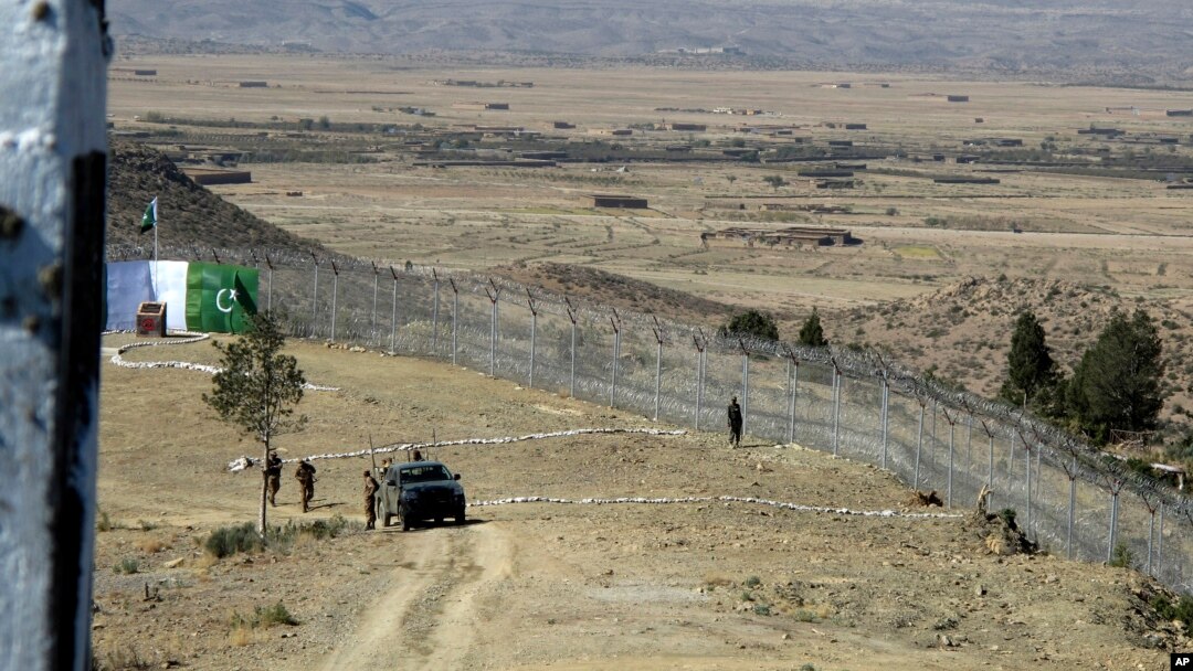 FILE - Pakistani soldiers stand guard at a newly erected fence between Pakistan and Afghanistan at Angore Adda, Pakistan, Oct. 18, 2017. 