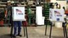 FILE - Voters cast their ballots at a polling station set up in a garage during the U.S. presidential election, near Fernald, Iowa, Nov. 8, 2016.