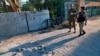 Security forces inspect the scene of a rocket attack at the gate of al-Zawra public park in Baghdad, Iraq, Nov. 18, 2020. Rockets struck Iraq's capital on Tuesday with four landing inside its heavily fortified Green Zone. 