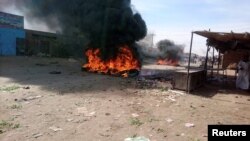 FILE - A bonfire is lit along the street during protests against price increases in Atbara, Nile River state in northeastern Sudan, Dec. 20, 2018.