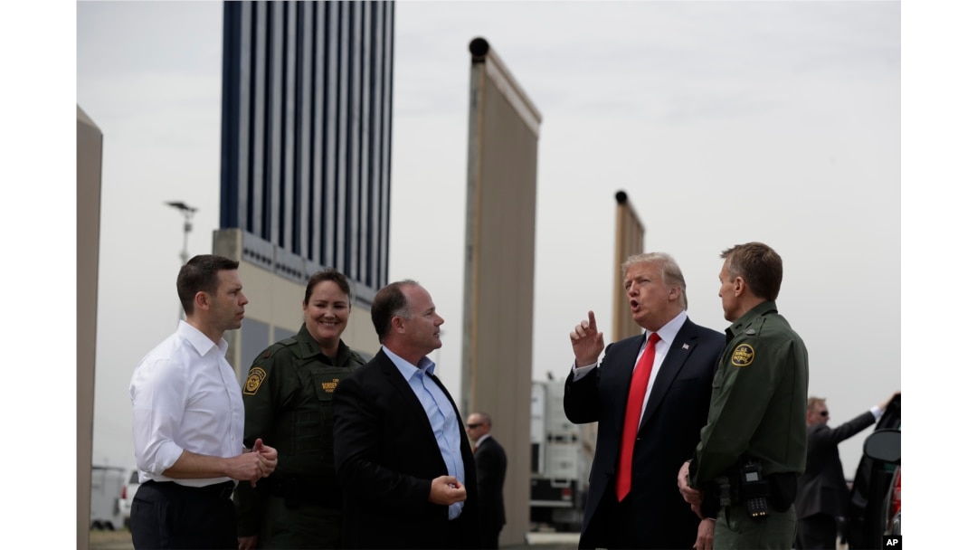 FILE - President Donald Trump reviews border wall prototypes, March 13, 2018, in San Diego.