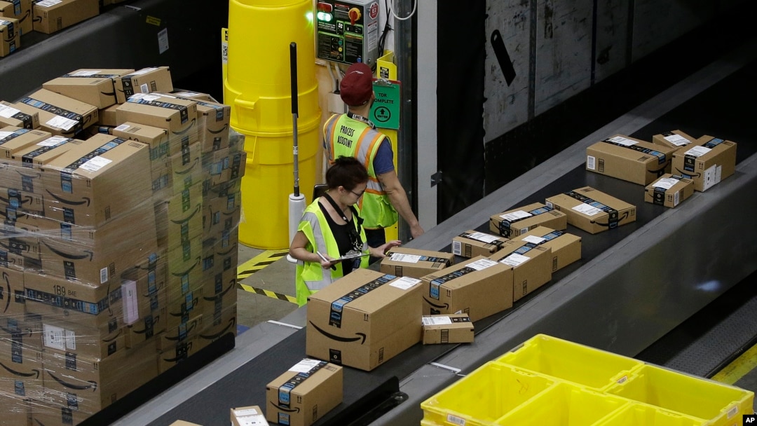 FILE - Packages move down a conveyor system were they are directed to the proper shipping area at the new Amazon Fulfillment Center, Feb. 9, 2018, in Sacramento, Calif. 