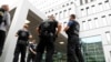 FILE - Police officers guard the surroundings of the Charite Mitte Hospital Complex, where Russian opposition leader Alexei Navalny is receiving medical treatment, in Berlin, Germany, Aug. 22, 2020. 