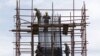 Workers stand on scaffolding at a road construction site in Beijing (File).