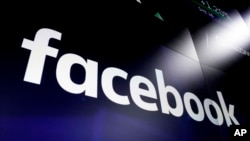 FILE - This March 29, 2018, photo shows the logo for Facebook on screens at the Nasdaq MarketSite, in New York's Times Square.