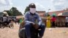 A boy sits on a bag at the old taxi park in Kampala, Uganda, on June 04, 2020, the first day of re-opening public transport.