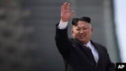 지난 15일 북한 태양절에 평양 김일성광장에서 열린 대규모 열병식에서 김정은 국무위원장이 군중을 향해 손을 흔들고 있다.