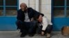 Mourners wait outside a morgue for the funeral of six Palestinians killed during an Israeli airstrike on Wednesday in the West Bank refugee camp of Jenin, Jan. 16, 2025.
