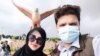 FILE - Syed Fawad Ali Shah, right, pictured with his wife in Langkawi, Malaysia, in early 2022.